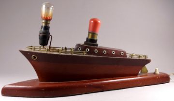 A mid 20th century table lamp modelled as boat - mahogany with brass fittings, length 41cm.