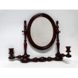 A late 19th/early 20th century stained beech bobbin turned mirror - with an oval plate and a pair of