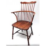 An early 19th century ash and elm comb back Windsor chair - of West Country type, probably