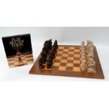 A late 20th century chess board and pieces - veneered in satin birch and palmwood, the resin cast