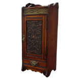 A late Victorian walnut and oak smoker's cabinet - with brass gallery above a carved panel door