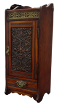 A late Victorian walnut and oak smoker's cabinet - with brass gallery above a carved panel door