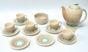 A Susie Cooper Art Deco coffee service - with 'Kestrel' pattern coffee pot, five cups, seven saucers