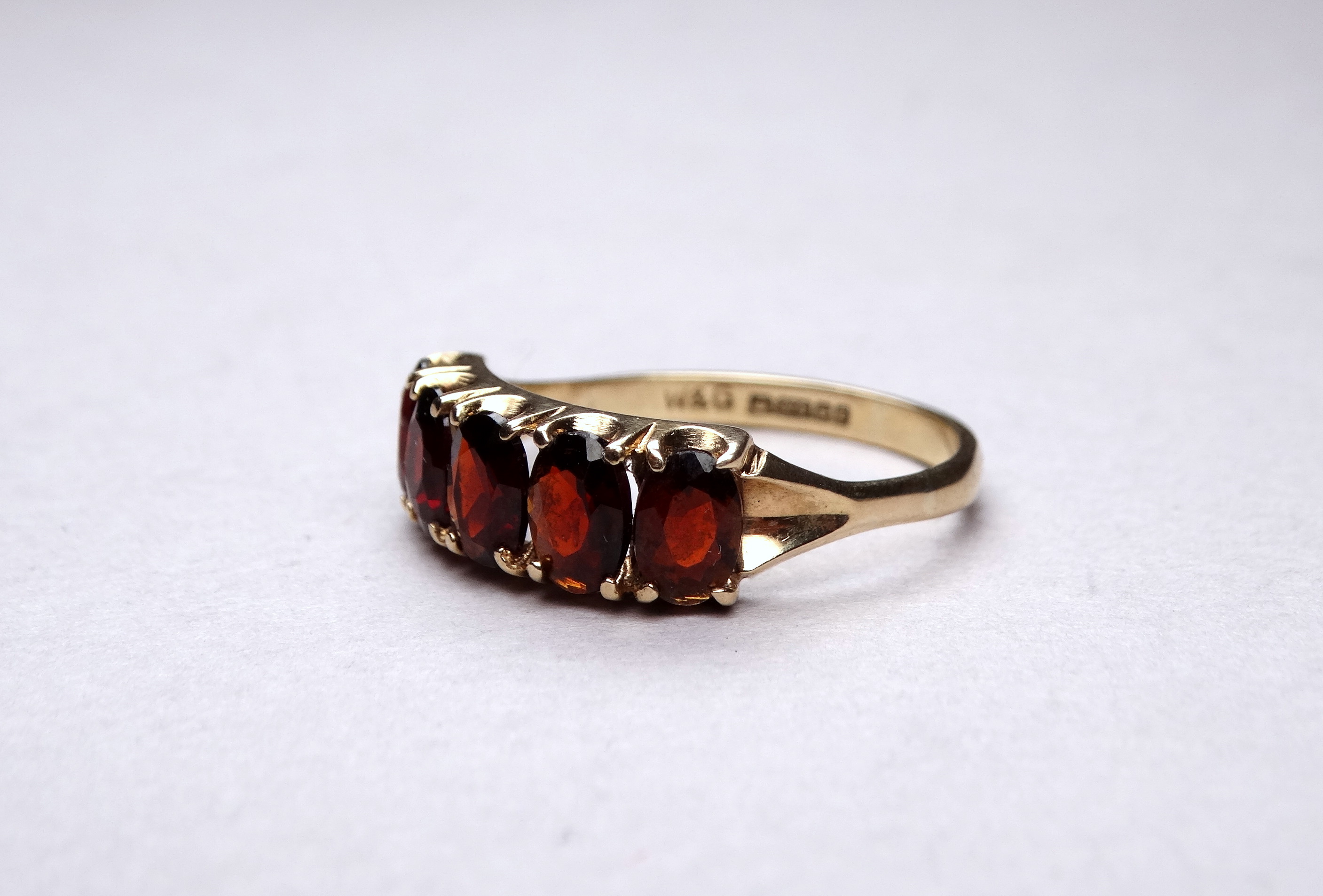 A 9ct yellow gold five stone garnet ring - claw set oval stones, ring size R-S, weight 2.6g. - Image 3 of 5