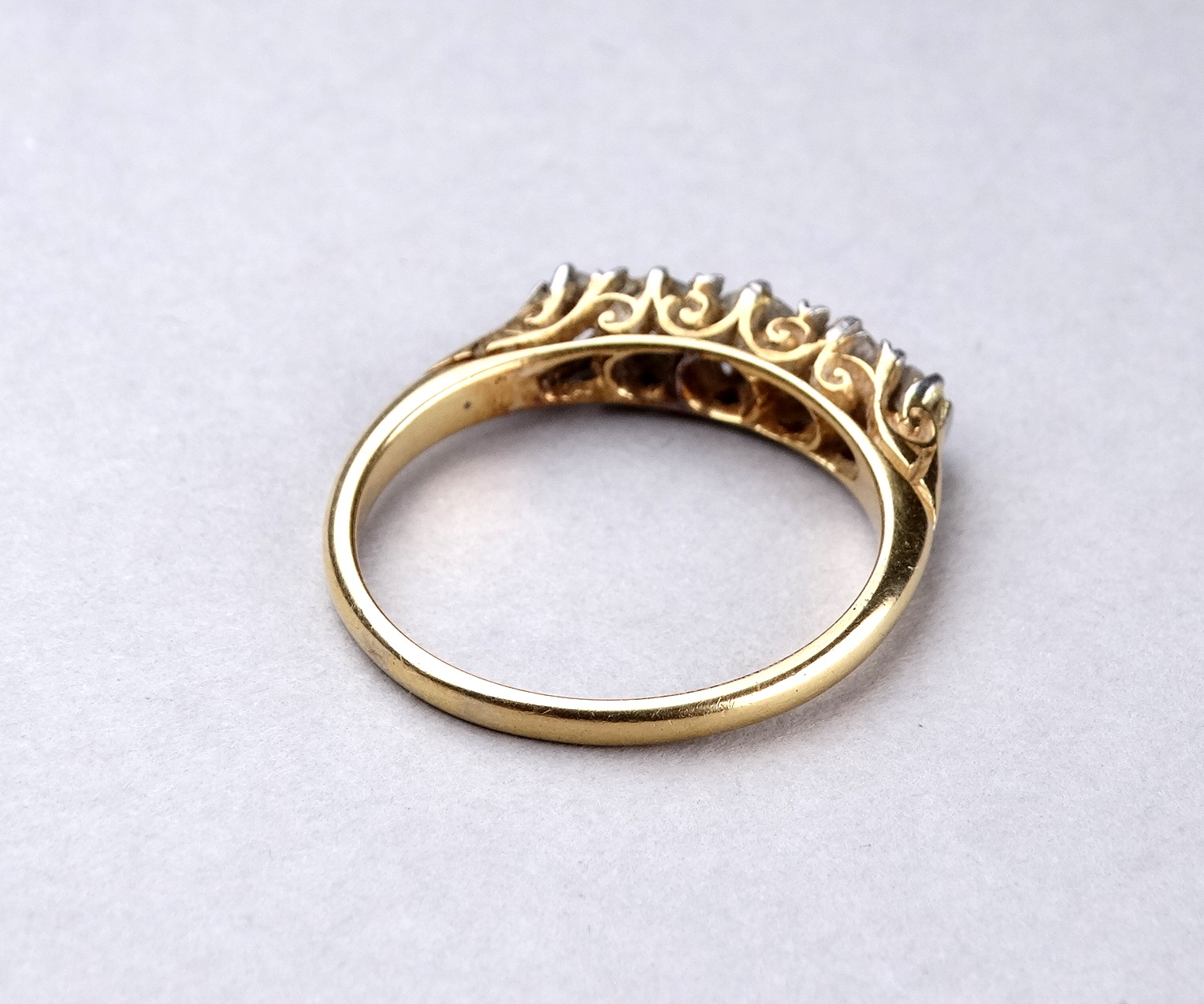 A five stone diamond ring - with a foliate scroll setting on an 18ct yellow gold band, ring size - Image 2 of 3