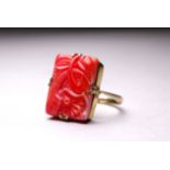 A 9ct yellow gold coral plaque ring - carved with a flower, size Q, weight 3.8g.