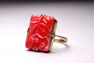 A 9ct yellow gold coral plaque ring - carved with a flower, size Q, weight 3.8g.