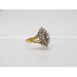 An 18ct gold diamond set twenty nine stone diamond cluster ring, the platinum claw set head of