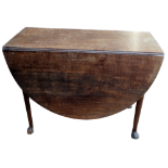 A George III oak drop leaf table - the oval top above a gateleg action, on turned legs ending in pad