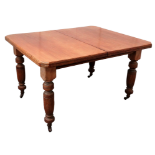 A late Victorian walnut extending dining table - the top with cusped corners on turned and reeded