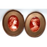 A pair of 19th century oval porcelain plaques - depicting elegant ladies, indistinctly signed