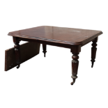 A Victorian mahogany dining table - the moulded rectangular top incorporating a winding mechanism on