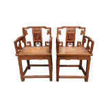 A pair of early 20th century Chinese elm open arm chairs - the splats decorated with images of