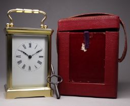 A 20th century carriage timepiece - with corniche case and white enamel dial set out in Roman