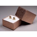 A pair of 9ct yellow gold ear studs - weight 0.7g.