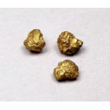 Three small yellow metal nuggets - weight 1.5g.