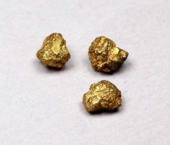 Three small yellow metal nuggets - weight 1.5g.