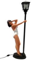 A 20th century cast resin table lamp - modelled as an exotic lady in white swimsuit below a street