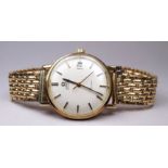 A 9ct yellow gold gentleman's Omega De Ville automatic wristwatch - with baton numerals on a cream