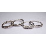 A platinum wedding band - ring size X, weight 3.4g, together with two eternity bands and a five