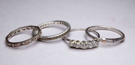 A platinum wedding band - ring size X, weight 3.4g, together with two eternity bands and a five