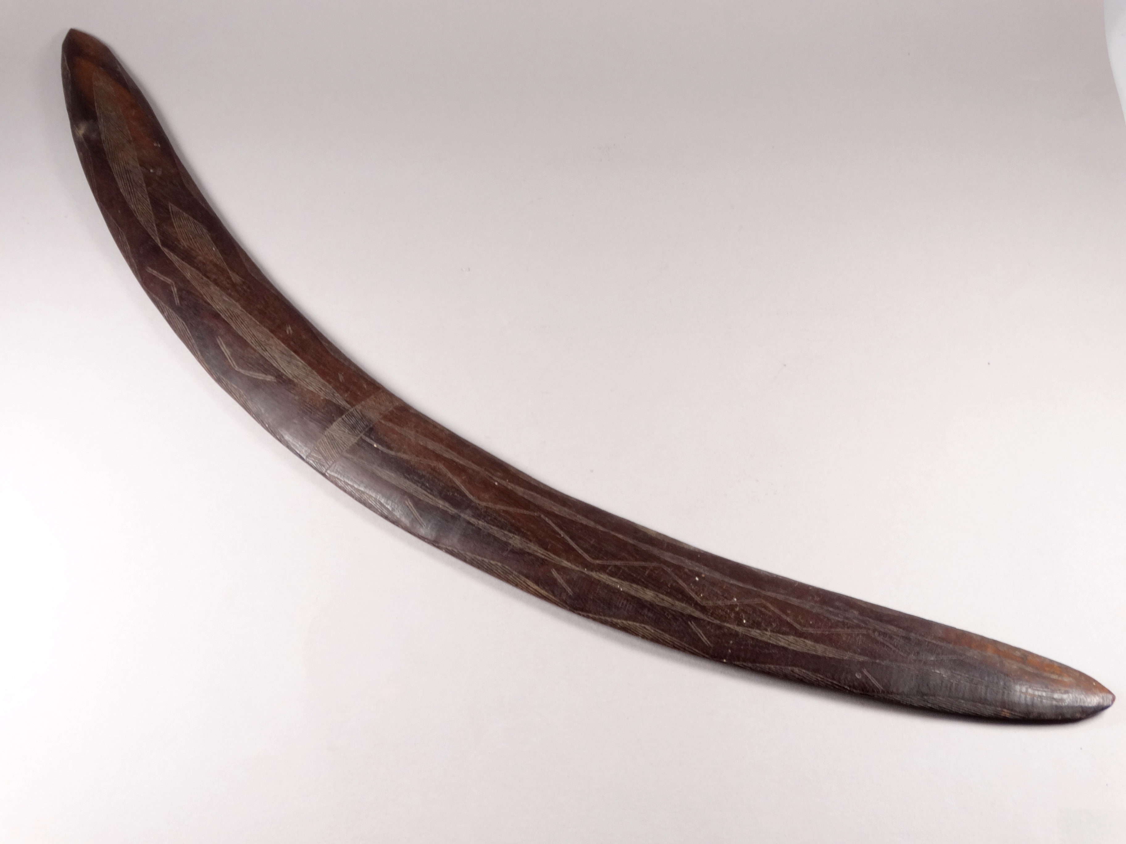 An early 20th century Australian hardwood boomerang - with linear incised panel decoration, length - Image 2 of 5