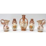 A pair of late 19th century blush ivory porcelain vases by Ernst Wahliss - with reticulated necks