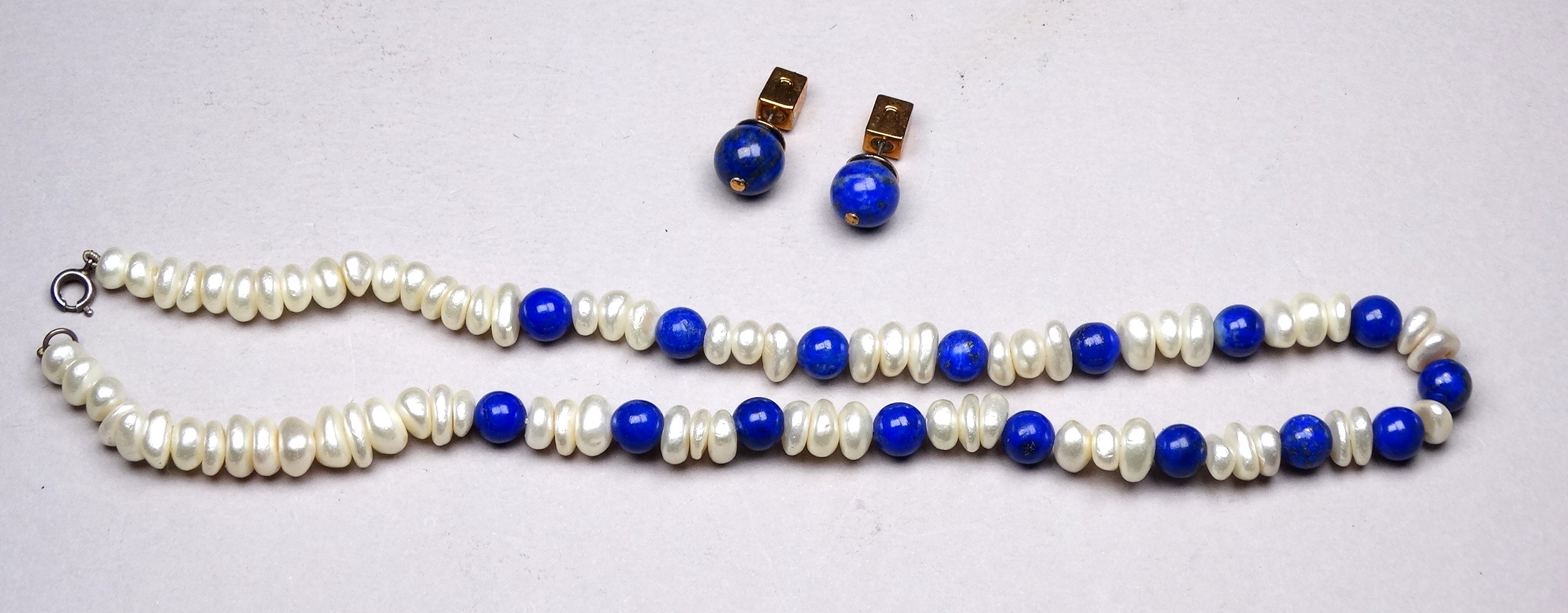 A lapis lazuli and seed pearl necklace - with an alternating arrangement of asymmetrical pearls
