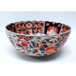 A late 19th century Imari bowl - with a scalloped rim and of typical palette, decorated with