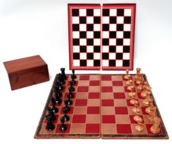 A late 19th/early 20th century Staunton chess set - the weighted pieces in boxwood and coloured