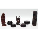 An early 20th century Chinese carved hardwood figure - with pigtails, standing holding a bird,