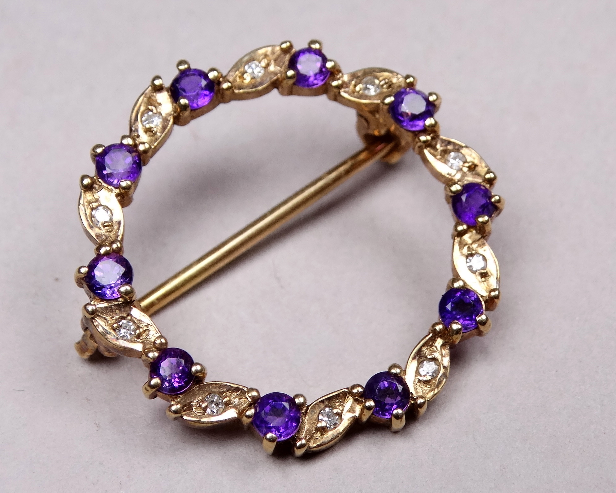 A 9ct yellow gold amethyst and diamond annular brooch - with a leaf setting, weight 2.8g. - Image 2 of 4