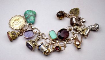 A 9ct yellow gold charm bracelet - with a selection of mixed gold charms, including a twenty