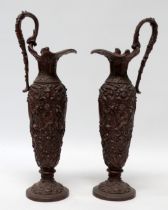 A pair of early 20th century spelter bacchanalian jugs - decorated in low relief with masks and