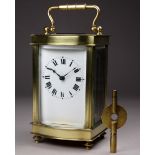 A 20th century carriage timepiece - the case with an ogee front and fitted with a white enamel