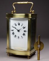 A 20th century carriage timepiece - the case with an ogee front and fitted with a white enamel