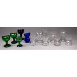Thirteen various glass eye baths - a variety of forms and shapes.