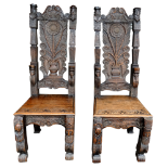 A pair of 17th century style carved oak chairs - the panel backs with flowers and foliage flanked by