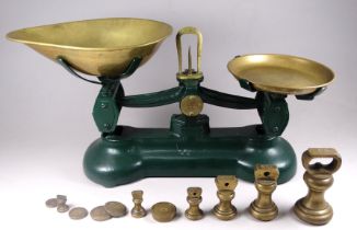 A pair of kitchen balance scales - with brass pans and a green painted body, together with a set