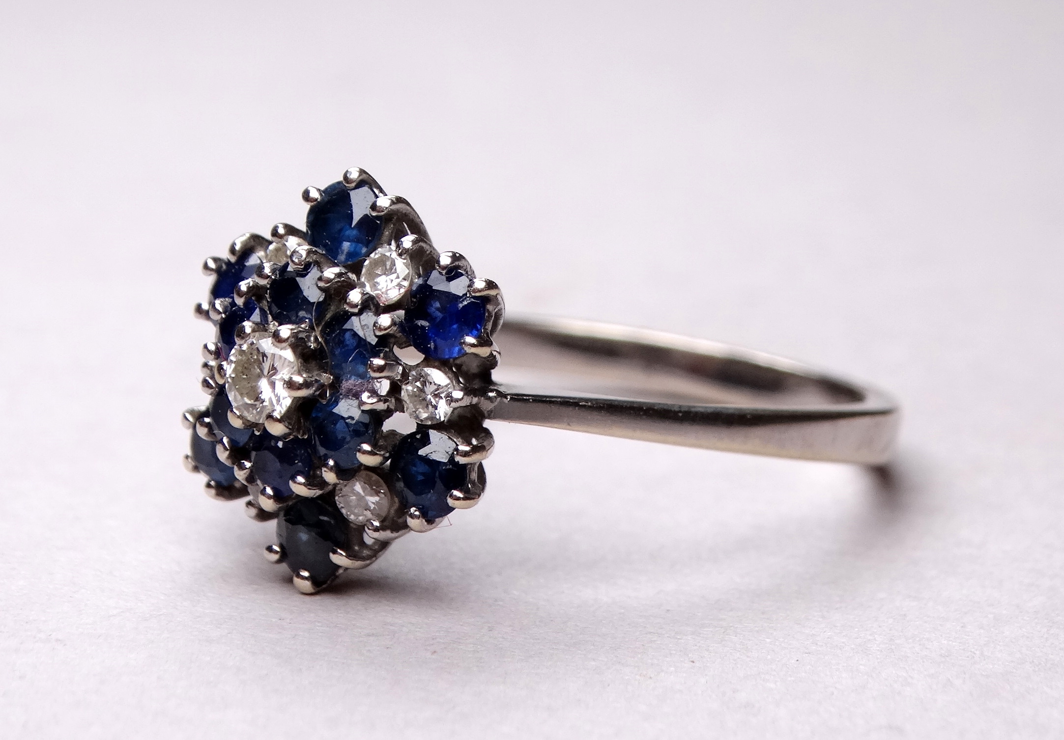 An 18ct white gold blue topaz and diamond set ring - the cluster setting in three steps, ring size - Image 2 of 3