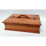 A 19th century two division pine cutlery box - with a central handle flanked by lidded compartments,