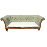 A late Victorian walnut and upholstered Chesterfield sofa - of typical buttoned form and raised on