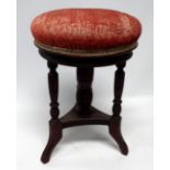 A late Victorian walnut piano stool - with circular adjustable seat on three turned supports