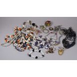 A quantity of costume jewellery - including floral brooches.