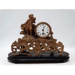 A late 19th century gilt spelter mantel clock - modelled with a vagabond standing beside the white
