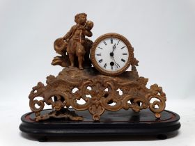 A late 19th century gilt spelter mantel clock - modelled with a vagabond standing beside the white