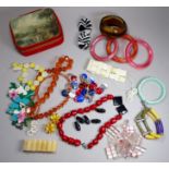 A quantity of costume jewellery - including a jade coloured floral cast bangle.