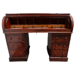A Victorian mahogany kneehole roll top desk - opening to reveal an arrangement of drawers, pigeon