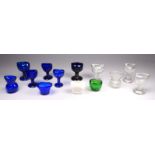 Thirteen various glass eye baths - a variety of forms and shapes.