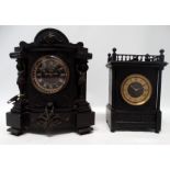 A late 19h century black slate mantel clock - the case incorporating caryatid supports about a black